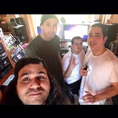 band members in recording room